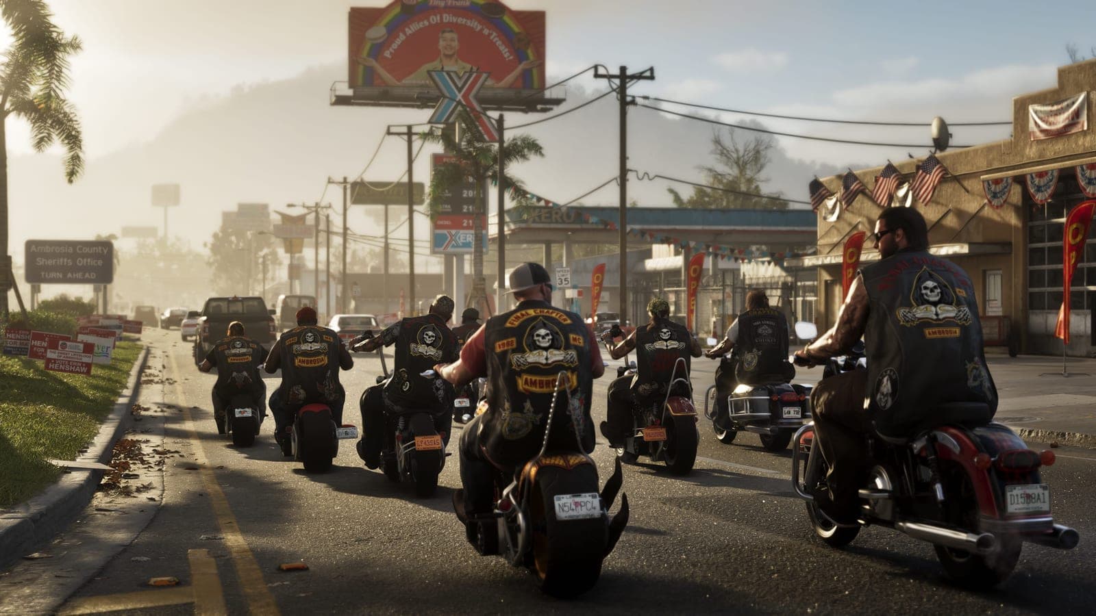 A group of bikers riding along a highway past roadside billboards.