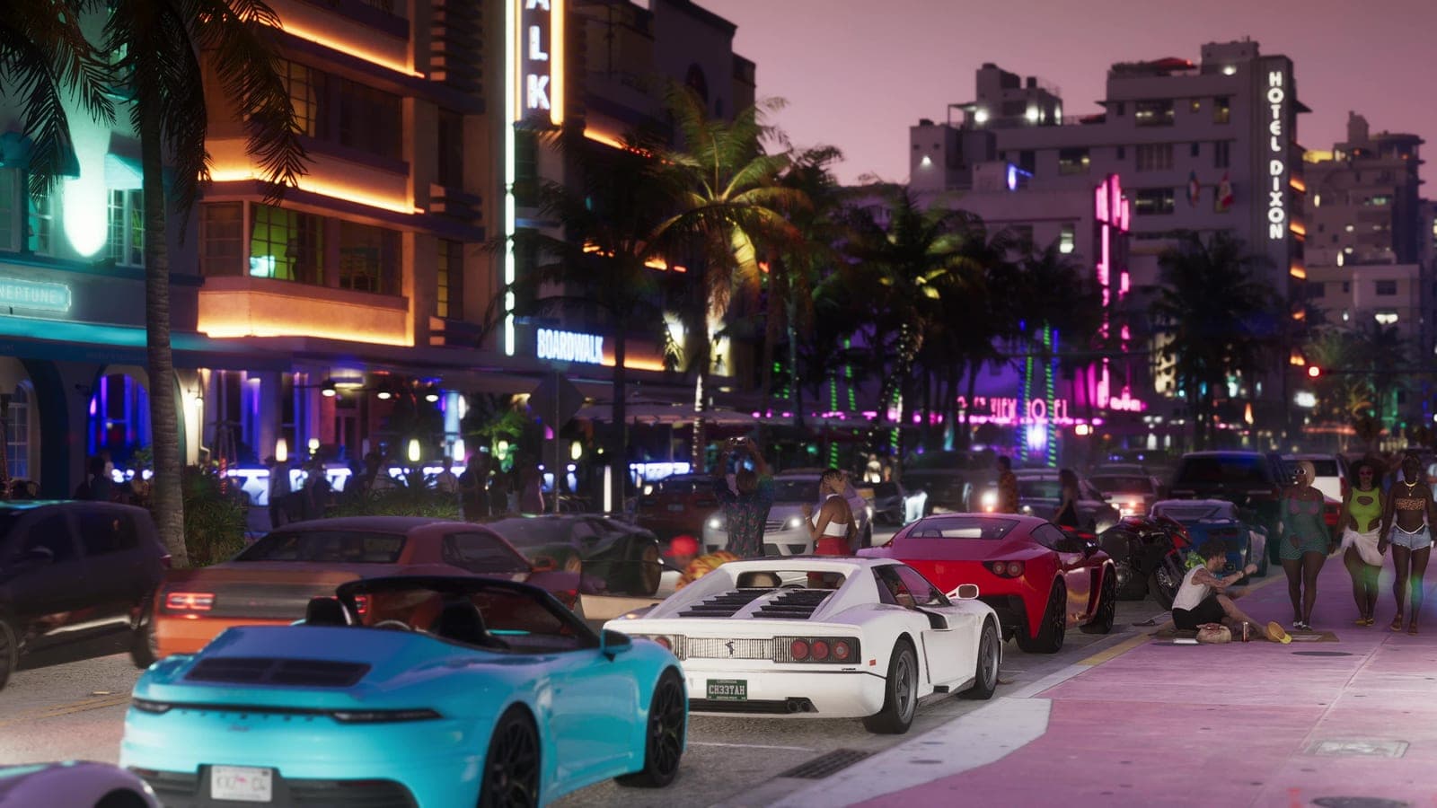 Ocean Drive at night, neon hotel fronts on one side and sports cars queuing along the palm-lined street.